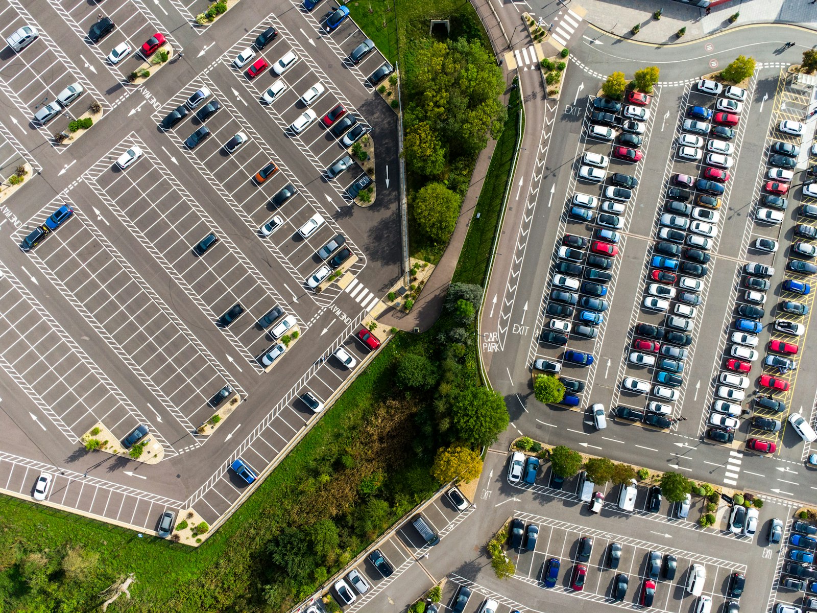 Aerial view of a dealership lot packed with parked used cars