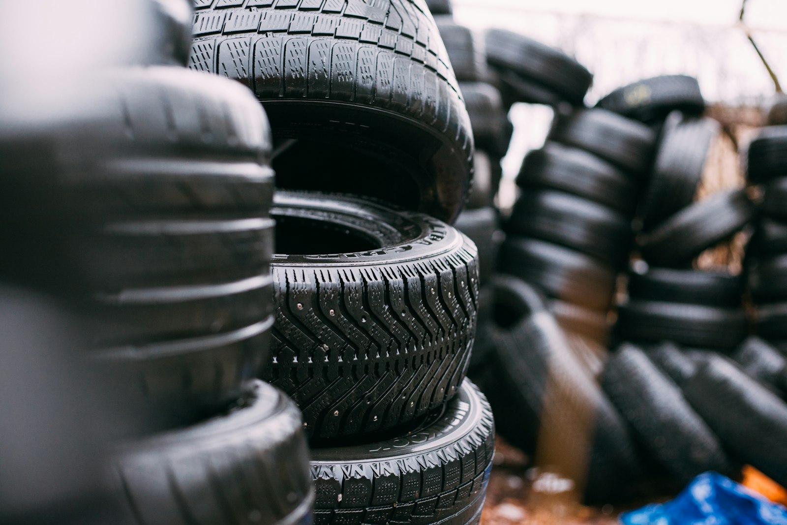 Stacks of used tires waiting in a tire yard